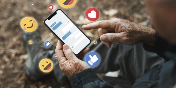 Senior man receiving positive reactions from social media